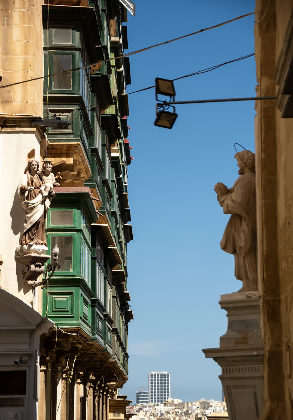 Traditional enclosed wooden gallarija balconies on a Valletta street facade